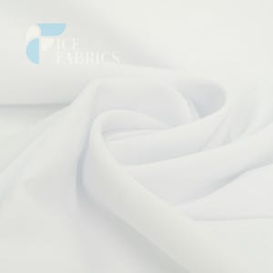 May include: A solid white fabric with a smooth, opaque texture, featuring soft folds and drapes that create subtle shadows. The top left corner displays a light blue and white logo with the text ICE FABRICS in a clean, sans-serif font.