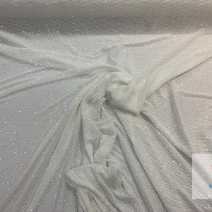 May include: White fabric with a subtle shimmer and a ribbed texture. The fabric is draped and folded, showing the texture and sheen.