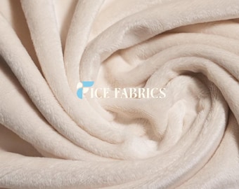 May include: A soft, off-white plush fabric with a dense, velvety texture and deep, flowing folds. The material features a short, uniform pile that catches the light, creating subtle shadows. The text ICE FABRICS is printed in white.