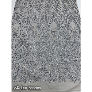 May include: Silver sequined fabric with a floral pattern. The fabric has a sheer mesh backing.