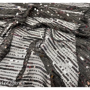 May include: Black sequined fabric with silver and iridescent sequins arranged in horizontal stripes on a black mesh background.