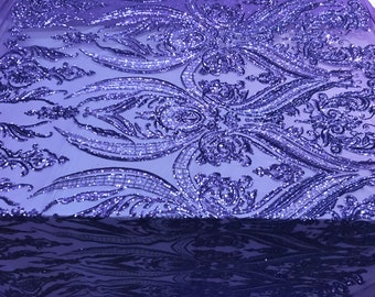 May include: Purple sequined fabric with a damask pattern. The sequins are iridescent and create a shimmering effect.