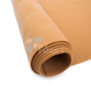 May include: A roll of solid tan felt fabric with a soft, matte texture. The material is tightly wound, showing multiple layers of the light brown textile. A semi-transparent logo with the text ICE FABRICS is visible on the surface of the roll.