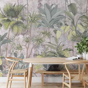 May include: A dining room set with a wooden table and chairs, featuring a tropical jungle mural wallpaper with green and brown leaves. The table is set with a magazine and a white mug.
