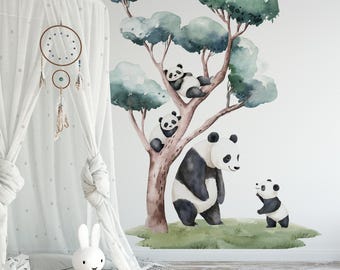 May include: Watercolor wall decal featuring a family of pandas in a tree. The tree has green and blue foliage, with a large panda standing on the ground and two smaller pandas in the tree. A small panda is waving.