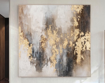 May include: Abstract painting with gold and brown accents on a canvas. The painting is hanging on a white wall in a modern interior.