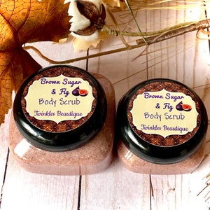 May include: Two glass jars of brown sugar and fig body scrub with black lids and gold glitter labels. The labels read "Brown Sugar & Fig Body Scrub" and "Twinkles Beautique".