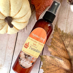 May include: A 4 oz bottle of Marshmallow Pumpkin Latte scented fragrance spray. The label is orange and features a cupcake icon and the text "Twinkles Sweet Shop".