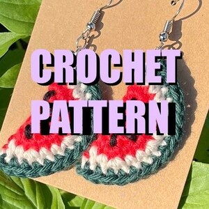 May include: Crochet pattern for watermelon earrings. The earrings are red, green and white and have a black seed detail. The earrings are hanging from silver earring hooks.
