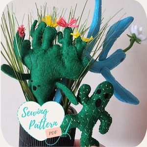 May include: A sewing pattern for a set of three felt cactus toys. The pattern includes a large cactus with multiple arms, a smaller cactus with two arms, and a blue cactus with a single arm. The pattern is available as a PDF download.