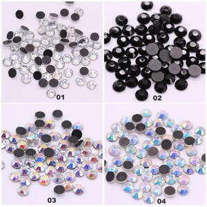 May include: Four groups of rhinestones with adhesive backs. The first group is clear, the second is black, the third is iridescent, and the fourth is iridescent. Each group is labeled with a number from 01 to 04.