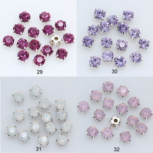 May include: Assortment of 20 round, flat-back rhinestones in four colors: fuchsia, lavender, white, and pink. The rhinestones are arranged in four groups of five, with each group labeled with a number from 29 to 32.