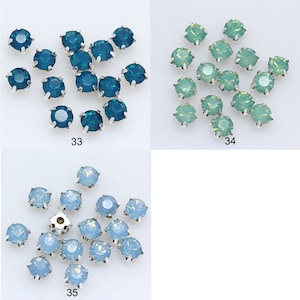 May include: Assortment of 18 round, faceted, glass rhinestones in three colors: teal, light green, and light blue. The rhinestones are arranged in three groups of six, with each group labeled with a number: 33, 34, and 35.