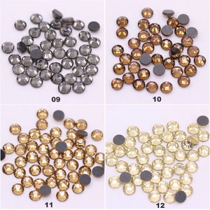 May include: Assortment of rhinestones in various colors, including black, brown, gold, and white. The rhinestones are arranged in four groups, each with a number below it: 09, 10, 11, and 12.