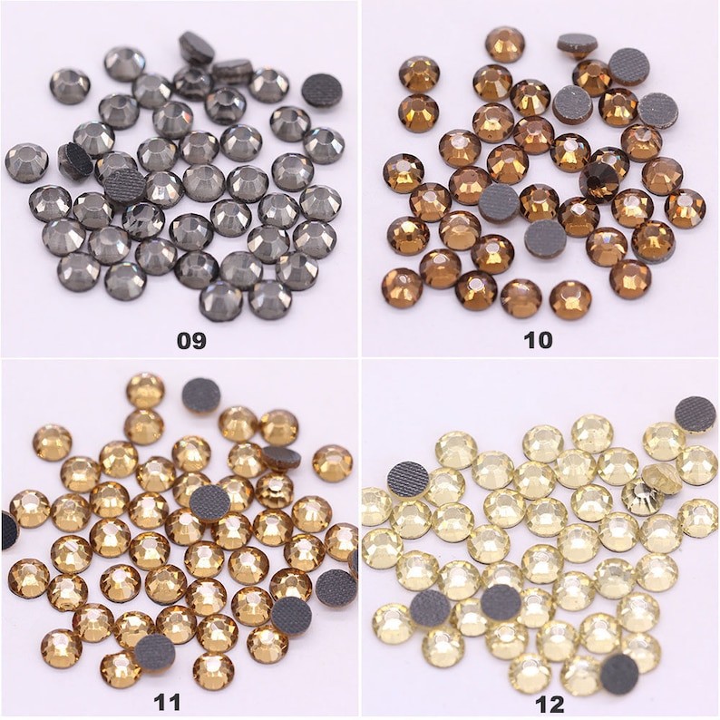May include: Assortment of rhinestones in various colors, including black, brown, gold, and white. The rhinestones are arranged in four groups, each with a number below it: 09, 10, 11, and 12.