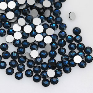 May include: A scattering of dark blue rhinestones with silver adhesive backs.