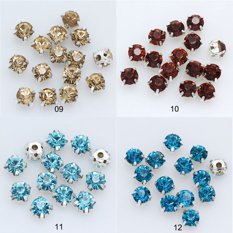 May include: Assortment of 12 round, flat-back rhinestones with silver settings. The rhinestones are in four colors: brown, red, blue, and light blue.