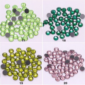 May include: Four groups of green, dark green, olive green, and pink rhinestones. Each group contains approximately 50 rhinestones.