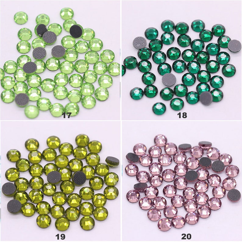 May include: Four groups of green, dark green, olive green, and pink rhinestones. Each group contains approximately 50 rhinestones.