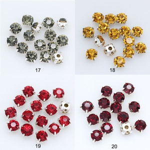 May include: Assortment of 16 silver-toned sew-on rhinestones in four colors: gray, gold, red, and dark red. Each rhinestone has a flat back with four prongs for sewing.
