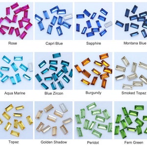 May include: Assortment of 12 colors of rectangular glass rhinestones. The colors are rose, capri blue, sapphire, montana blue, aqua marine, blue zircon, burgundy, smoked topaz, topaz, golden shadow, peridot, and fern green.