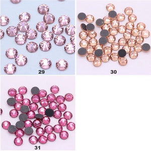 May include: Three groups of rhinestones, each group containing a different color. The first group is pink, the second is light brown, and the third is a darker pink. Each group is labeled with a number, 29, 30, and 31.