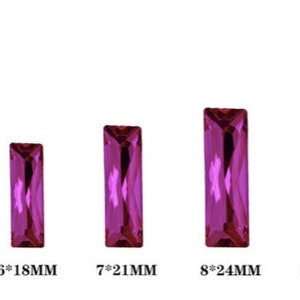 May include: Five different sizes of pink rectangular glass rhinestones. The rhinestones are arranged in a row from smallest to largest. The measurements of each rhinestone are listed below each one: 5 x 15 mm, 6 x 18 mm, 7 x 21 mm, 8 x 24 mm, and 10 x 30 mm.