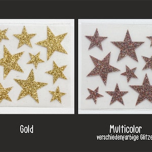 Op de afbeelding: Twee vellen met gouden en veelkleurige glitterster stickers. Het gouden vel heeft 10 gouden glittersterren. Het veelkleurige vel heeft 10 sterren met een mix van roze, rode en gouden glitter.