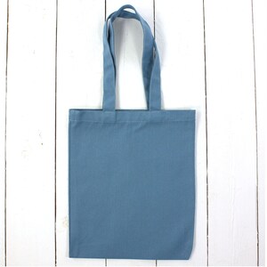 May include: A plain blue tote bag with two handles. The bag is made of a sturdy fabric and is perfect for carrying everyday essentials.