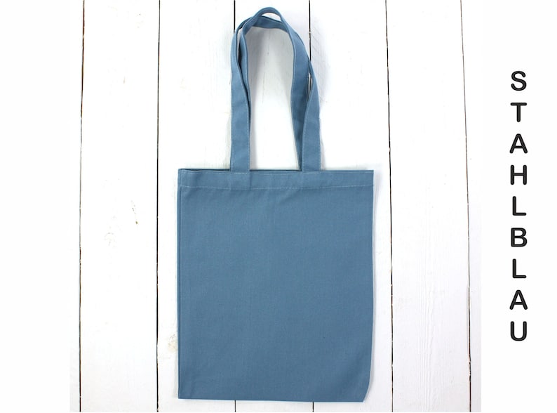 May include: A plain blue tote bag with two handles. The bag is made of a sturdy fabric and is perfect for carrying everyday essentials.