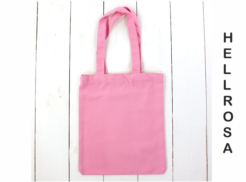 May include: A pink tote bag with a simple design, perfect for carrying everyday essentials.