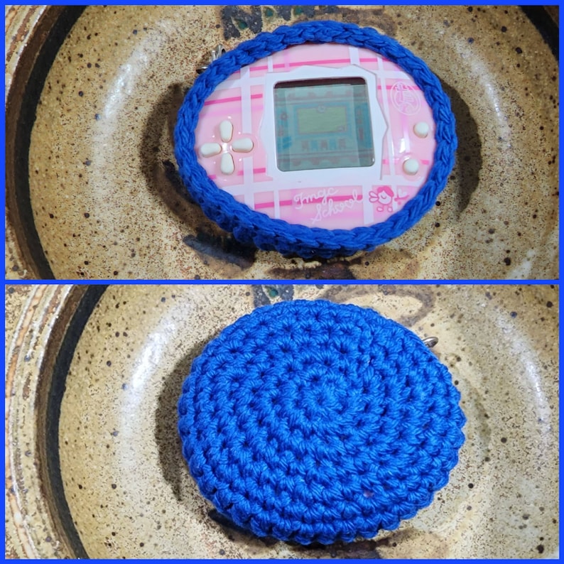 May include: A pink and blue digital pet toy with a screen that says "Tamagotchi" and a blue crocheted round coaster.