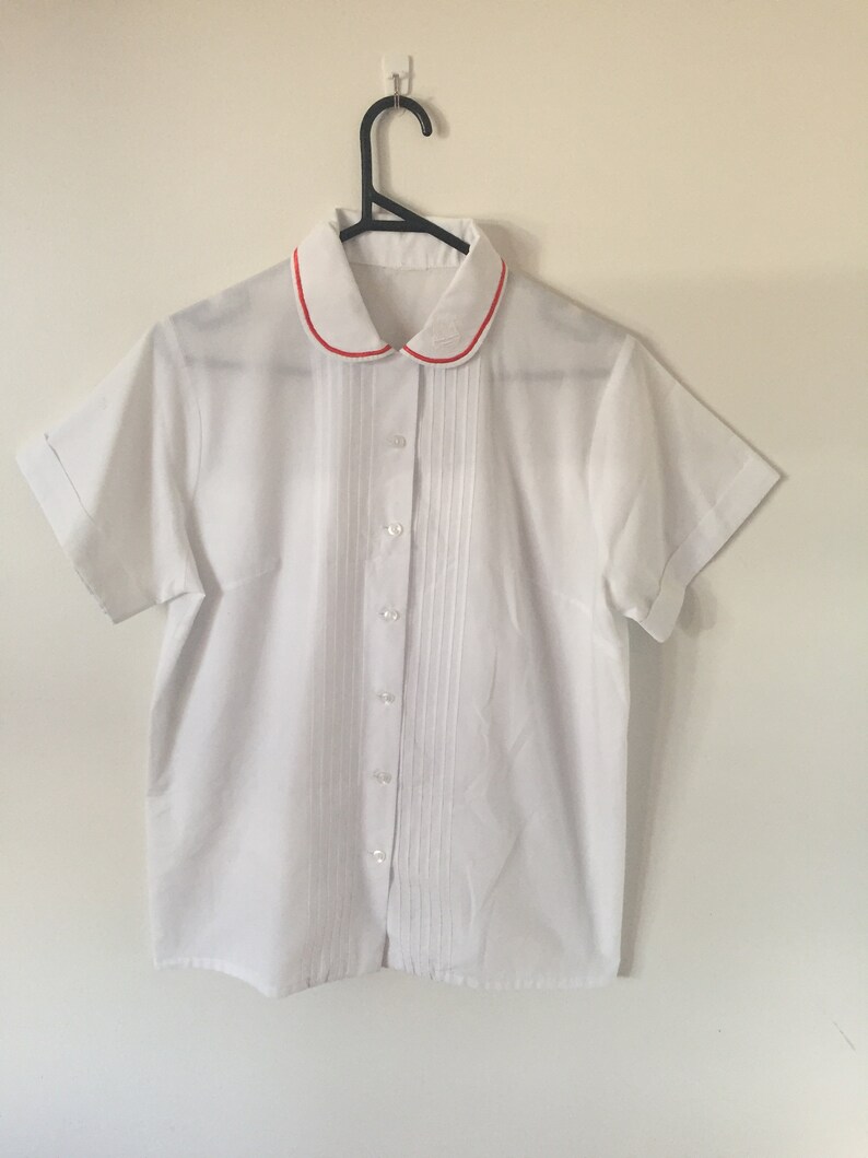 INCREDIBLE 80s White Peter Pan Collar Blouse with Embroidered Royal Crest and Red Piping