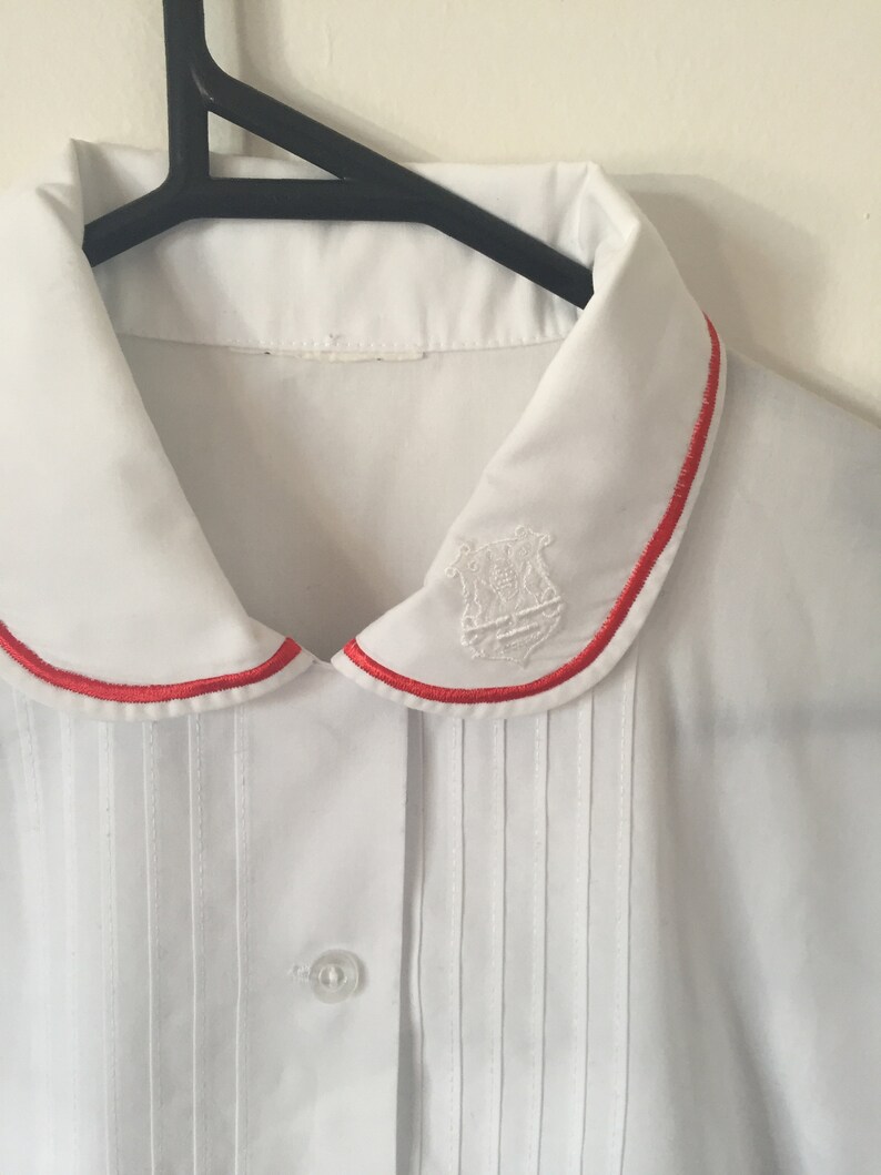 INCREDIBLE 80s White Peter Pan Collar Blouse with Embroidered Royal Crest and Red Piping