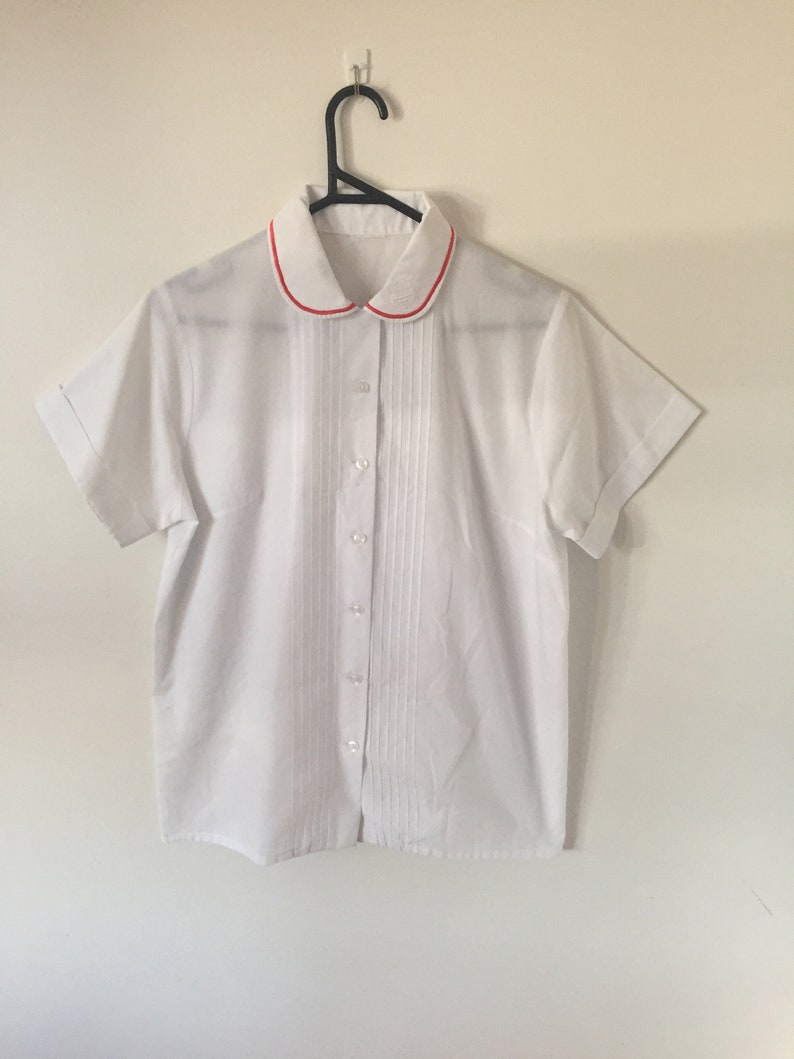 INCREDIBLE 80s White Peter Pan Collar Blouse with Embroidered Royal Crest and Red Piping