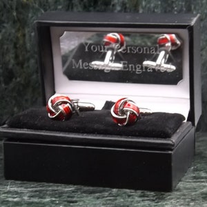May include: A pair of red and silver cufflinks in a black gift box. The box has a mirrored lid with the text "Your Personal Message Engraved".