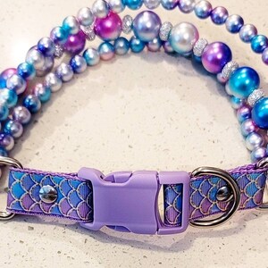 May include: A purple and blue beaded dog collar with a purple buckle and a mermaid scale pattern on the strap.