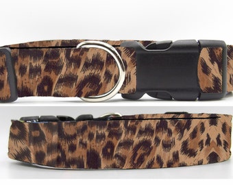 May include: A brown and black leopard print dog collar with a black plastic buckle and a silver metal D-ring.