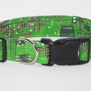 May include: Green dog collar with a circuit board pattern and a black plastic buckle. The collar has a silver metal D-ring.