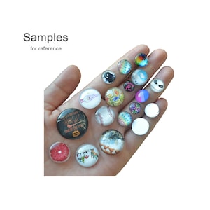 May include: A collection of round glass magnets with various designs, including a baseball, a Jack Skellington face, and a slice of grapefruit. The text "Samples for reference" is visible.