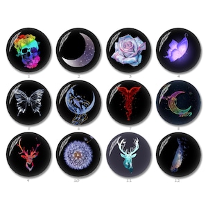 May include: A collection of twelve round, black glass cabochons with various designs. The designs include a colorful skull, a crescent moon, a rose, a butterfly, a deer, and a dandelion. The cabochons are suitable for jewelry making or crafting.