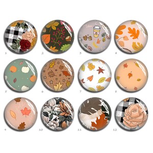 May include: Twelve round decorative magnets with autumn-themed designs. The magnets display patterns such as pumpkins, leaves, floral arrangements, and plaid. Colours include orange, brown, green, and cream.