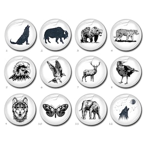 May include: Twelve black and white illustrations of animals and nature on a white background. The illustrations include a wolf, a bison, a bear, a tiger, an eagle, a bird, a deer, a raven, a wolf, a butterfly, an elephant, and a wolf howling at the moon.