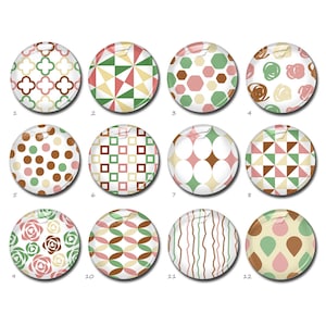 Può includere: Una collezione di dodici bottoni circolari disposti in una griglia, ognuno caratterizzato da un motivo distinto nelle tonalità del verde, marrone e rosa. I design includono forme geometriche, motivi floreali, pois, strisce e scarabocchi.