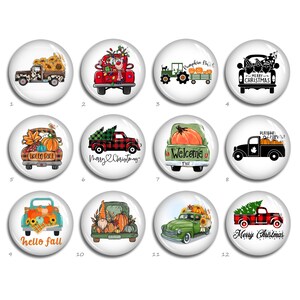 May include: Twelve round, white, glossy buttons with images of vintage pickup trucks decorated with fall and Christmas themes. The trucks are carrying pumpkins, sunflowers, Christmas trees, and gnomes. The buttons have text that says "Hello Fall", "Welcome Fall", "Merry Christmas", and "Pumpkin Patch".
