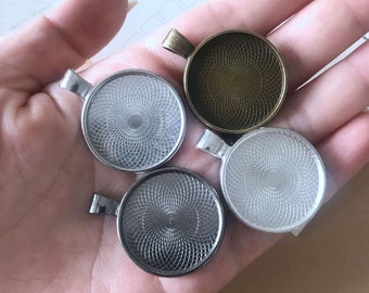 May include: Four silver and bronze pendant trays with a decorative pattern. The trays are round and have a raised edge.