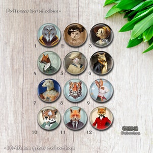 Könnte beinhalten: Zwölf Glascabochons mit Tierporträts, darunter eine Eule, eine Katze, ein Fuchs und ein Tiger. Der Text lautet "Patterns for choice -" und "-10-40mm glass cabochon". Jeder Cabochon hat einen Durchmesser von etwa 10-40mm.