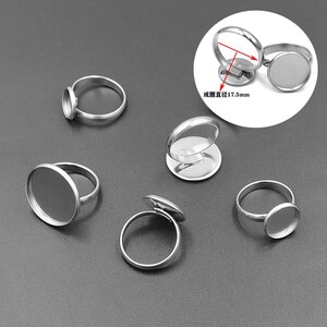 May include: Six silver rings with round, clear glass inserts. The rings are adjustable and have a diameter of 17.5 mm.