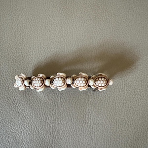 Beige & brown colored turtles on 80mm French hair barrette. Great for beach outings including beach weddings.