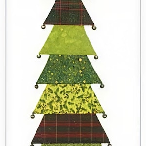 May include: A decorative Christmas tree made of layered fabric triangles in various shades of green and red plaid. The tree is topped with a brown star and has small silver beads. The text "mp studios" and "For Evergreen" are at the top and bottom.